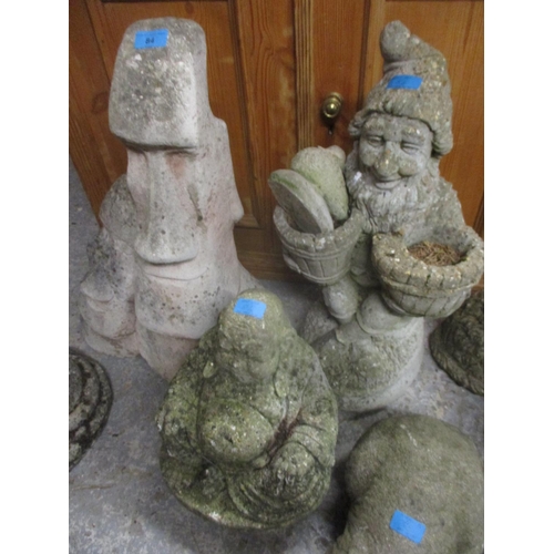 84 - Composition stone garden figures Easter Island figure, a model of a dog, gnomes, a model cat, a face... 