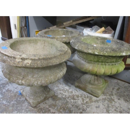 89 - A pair of composition stone garden planters with gadroon ornaments 39cm high x 44cm dia, and one oth... 