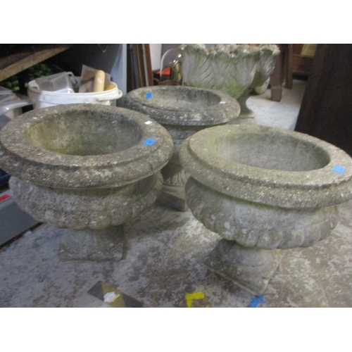 89 - A pair of composition stone garden planters with gadroon ornaments 39cm high x 44cm dia, and one oth... 