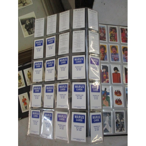 A collection of cigarette cards to include Beatles Warus cards, together  with a large photograph alb