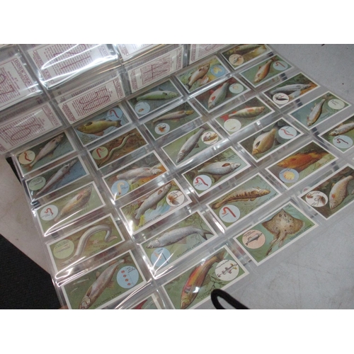 A collection of cigarette cards to include Beatles Warus cards, together  with a large photograph alb