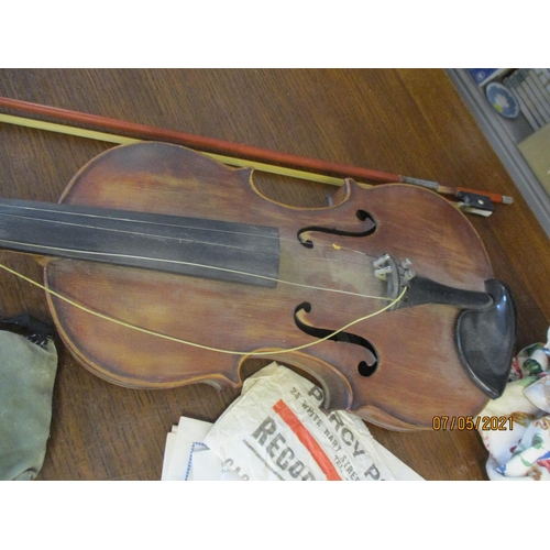 373 - A 20th century violin A/F, bow and accessories together with a collection of books to include Alice ... 