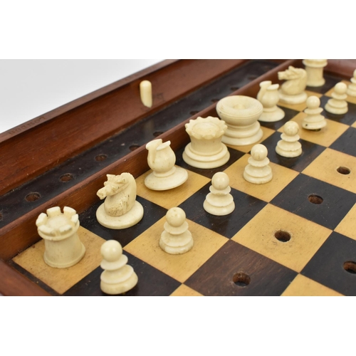 178 - A late 19th/early 20th century Jacques & Sons travelling chess set, with carved bone pieces on a mar... 