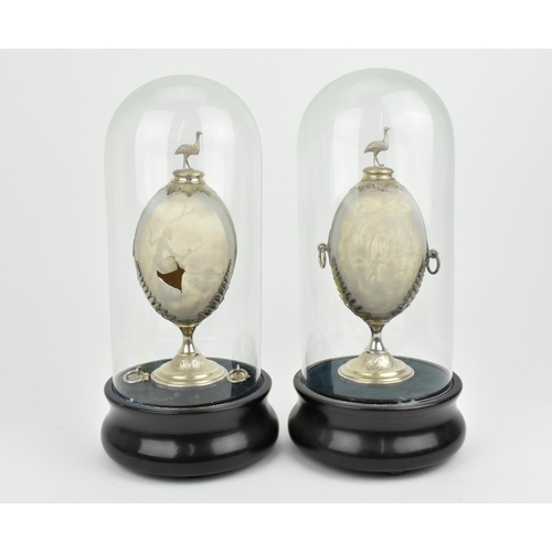 194 - A pair of late 19th/early 20th century carved Australian emu eggs mounted with white metal surmount ... 