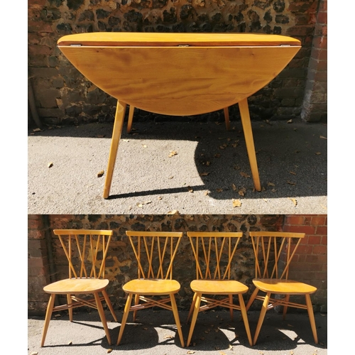 199 - A blonde elm Ercol drop leaf circular dining table, together with six candlestick lattice beech and ... 