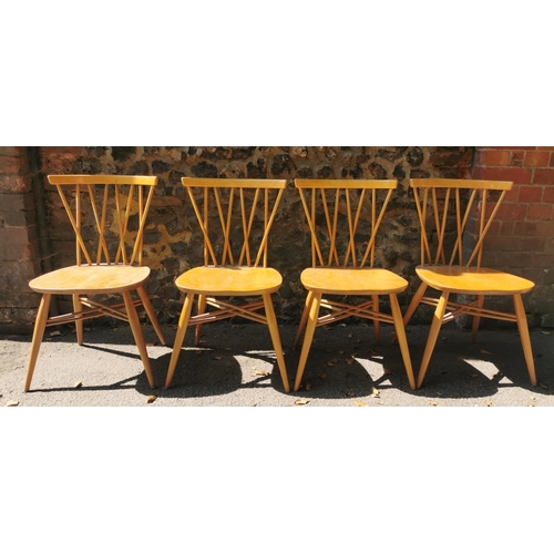 199 - A blonde elm Ercol drop leaf circular dining table, together with six candlestick lattice beech and ... 