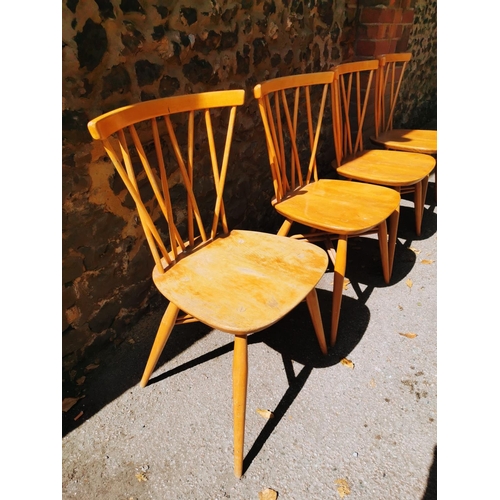 199 - A blonde elm Ercol drop leaf circular dining table, together with six candlestick lattice beech and ... 