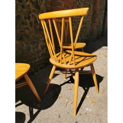 199 - A blonde elm Ercol drop leaf circular dining table, together with six candlestick lattice beech and ... 