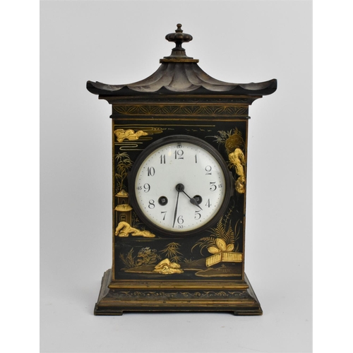 64 - An early 20th century Japanned mantle clock in the form of a pagoda having an enamel dial with Arabi... 