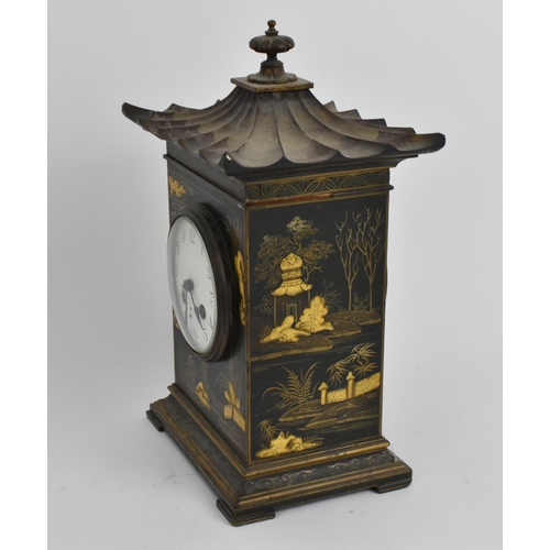 64 - An early 20th century Japanned mantle clock in the form of a pagoda having an enamel dial with Arabi... 