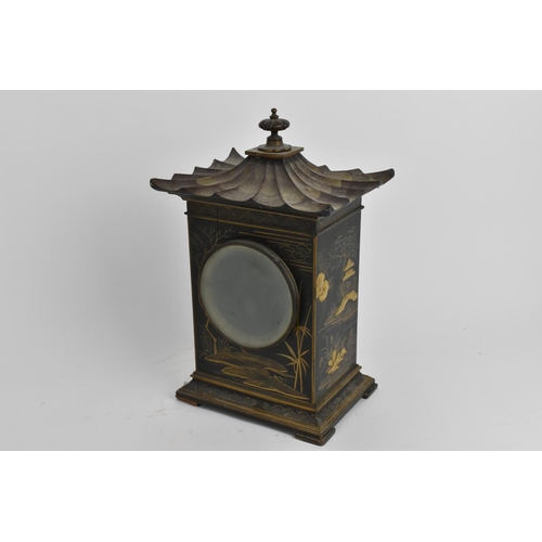 64 - An early 20th century Japanned mantle clock in the form of a pagoda having an enamel dial with Arabi... 