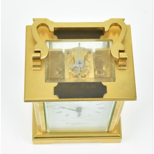 68 - A late 20th century brass cased carriage clock having a white enamel dial with Roman numerals, Bregu... 