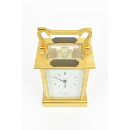 68 - A late 20th century brass cased carriage clock having a white enamel dial with Roman numerals, Bregu... 