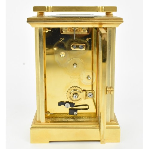 68 - A late 20th century brass cased carriage clock having a white enamel dial with Roman numerals, Bregu... 