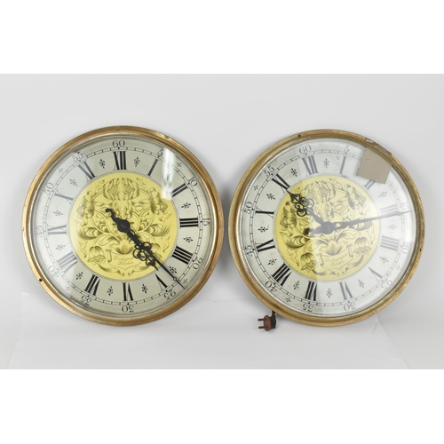 69 - A pair of Magneta Impulse Movement slave clocks, having 12 inch dials with floral engraved centres, ... 