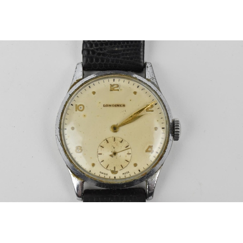 205 - A chrome gent's circa 1950, Longines Wristwatch. Having gilt hands with subsidiary seconds dial and ... 