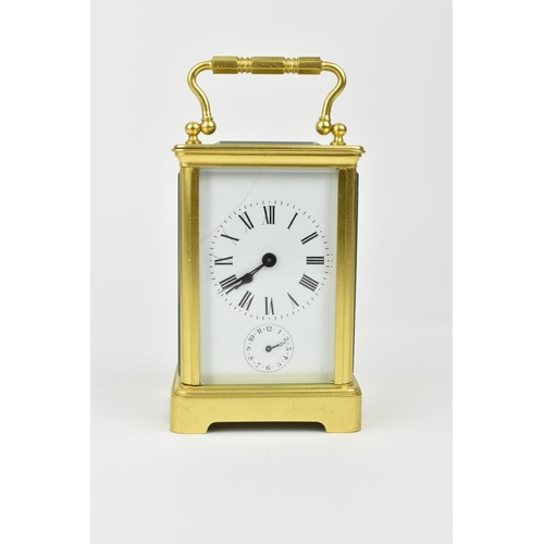 220 - A brass cased carriage clock with alarm. Having a white enamel dial with Roman numerals and Arabic s... 