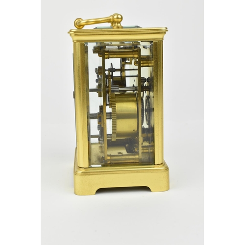 220 - A brass cased carriage clock with alarm. Having a white enamel dial with Roman numerals and Arabic s... 