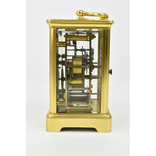 220 - A brass cased carriage clock with alarm. Having a white enamel dial with Roman numerals and Arabic s... 