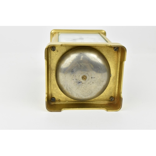 220 - A brass cased carriage clock with alarm. Having a white enamel dial with Roman numerals and Arabic s... 