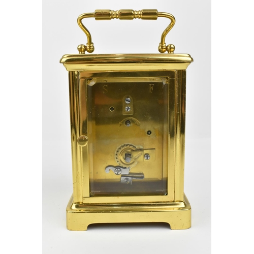 221 - A pair of brass cased carriage clocks with enamel dials and having Roman numerals. One stamped 1858,... 