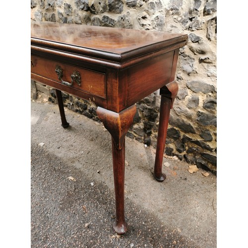 173 - A George III mahogany fold over tea table, with twin handled single frieze drawer, supported on four... 