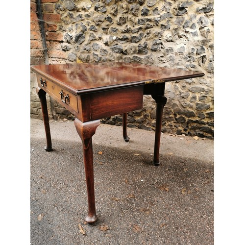 173 - A George III mahogany fold over tea table, with twin handled single frieze drawer, supported on four... 