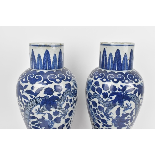 68 - A pair of Chinese Qing dynasty blue and white porcelain lidded vases, 19th century, of baluster shap... 