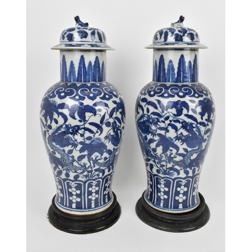 68 - A pair of Chinese Qing dynasty blue and white porcelain lidded vases, 19th century, of baluster shap... 