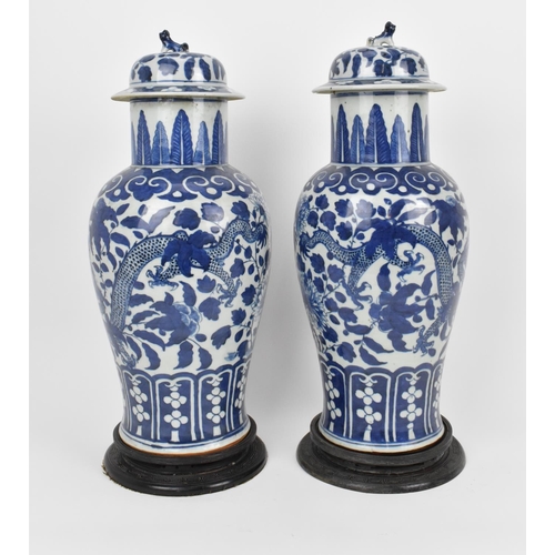 68 - A pair of Chinese Qing dynasty blue and white porcelain lidded vases, 19th century, of baluster shap... 