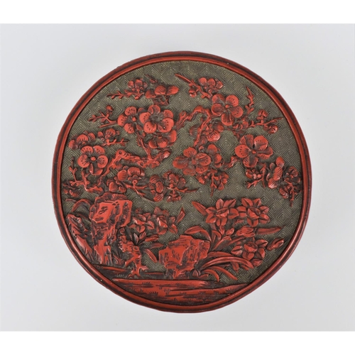 69 - A Chinese Qing dynasty carved cinnabar lacquer box, of cylindrical form, the lid with intricately de... 