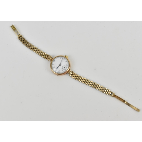 215 - A 9ct yellow gold 1932 ladies wristwatch, the enamel dial with arabic numerals, with articulated bra... 