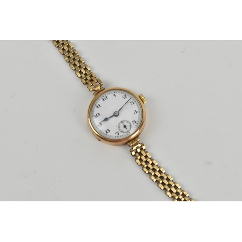 215 - A 9ct yellow gold 1932 ladies wristwatch, the enamel dial with arabic numerals, with articulated bra... 