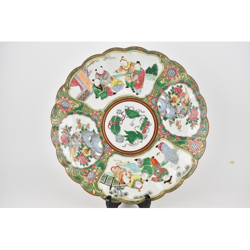 104 - A late Qing dynasty polychrome enamel charger with a wavy edge, scrolls and other objects to the cen... 