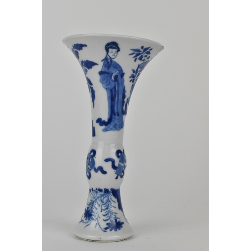 114 - A Chinese Kangxi porcelain blue and white gu vase decorated with two women standing either side of j... 