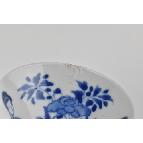 114 - A Chinese Kangxi porcelain blue and white gu vase decorated with two women standing either side of j... 