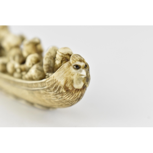 116 - A Japanese Meiji period ivory netsuke of a boat crowed with gods of good fortune, men, women and chi... 