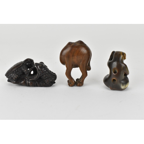 119 - Three 20th century netsuke, one of a camel and another of two frogs on a lily pad, signed to the bas... 