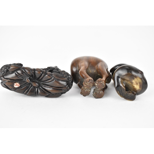 119 - Three 20th century netsuke, one of a camel and another of two frogs on a lily pad, signed to the bas... 