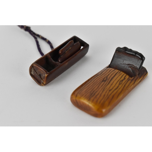 122 - Two Japanese 19th century stained ivory netsuke, one a woodworking plane with text to the underside ... 