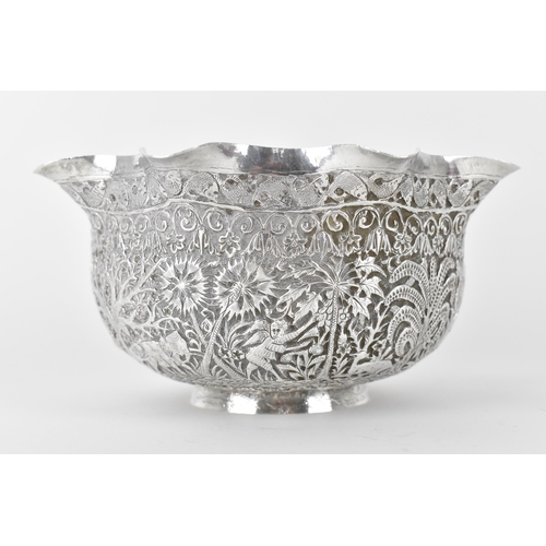 131 - A 19th century Burmese silver bowl embossed and chased with a continuous jungle scene of camel, elep... 