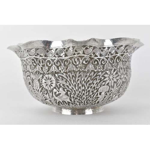 131 - A 19th century Burmese silver bowl embossed and chased with a continuous jungle scene of camel, elep... 