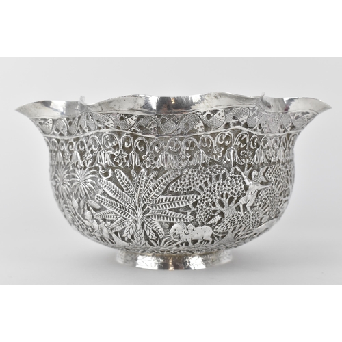 131 - A 19th century Burmese silver bowl embossed and chased with a continuous jungle scene of camel, elep... 