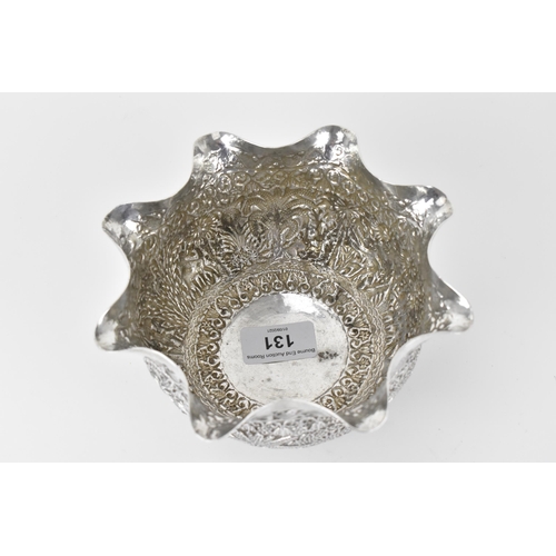 131 - A 19th century Burmese silver bowl embossed and chased with a continuous jungle scene of camel, elep... 