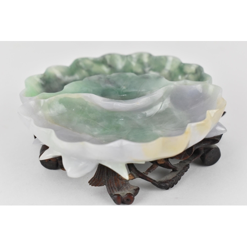 133 - A 20th century Chinese jadeite twin compartment bowl in the form of a water lily with flowers to the... 