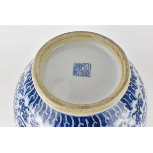 135 - A Chinese late Qing dynasty blue and white hu vase with twin bamboo handles, decorated with entwined... 