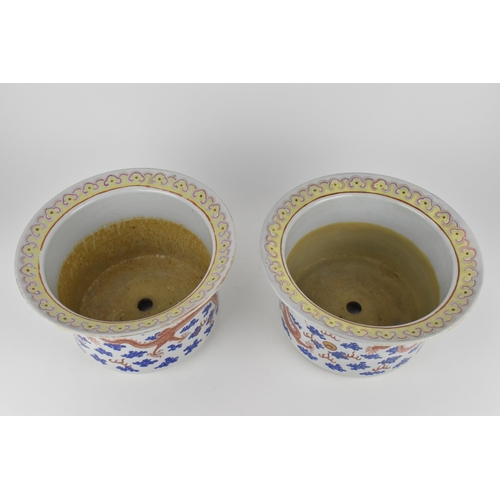 140 - A near pair of Chinese 20th century cylinder jardinières with flared rims and straight sides, decora... 