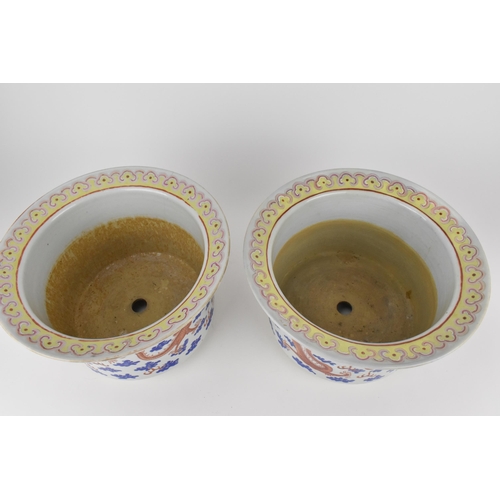 140 - A near pair of Chinese 20th century cylinder jardinières with flared rims and straight sides, decora... 