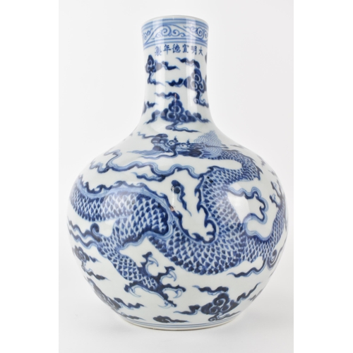 143 - A Chinese 20th century blue and white tianqiuping vase decorated with a dragon and clouds, 28cm h
Co... 