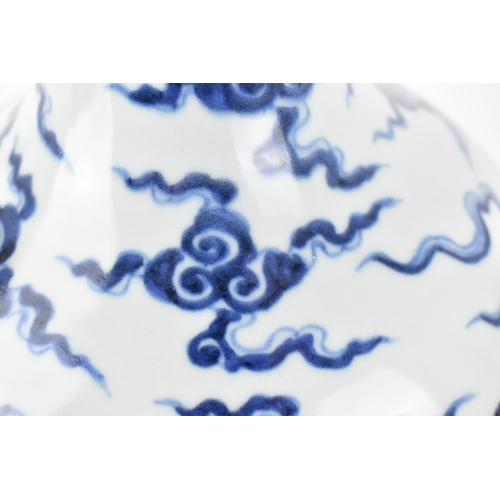 143 - A Chinese 20th century blue and white tianqiuping vase decorated with a dragon and clouds, 28cm h
Co... 